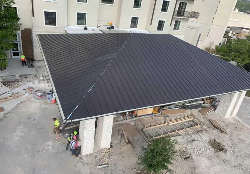 Metal roofing installation team working on a commercial building in Fishersville